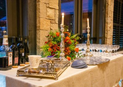 Table with candles, flowers, wines, and dining tools